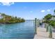 Scenic dock with wooden posts overlooking calm, clear waters and distant lush landscapes at 79 Palm Dr, Placida, FL 33946