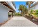 View of gravel driveway and tropical vegetation in rear of home at 79 Palm Dr, Placida, FL 33946