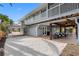 Back of home with an outdoor entertainment area under a covered patio with an outdoor living space and a carport at 79 Palm Dr, Placida, FL 33946