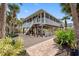 Beautiful home featuring large screened in porch, brick paver patio, and lush landscaping at 79 Palm Dr, Placida, FL 33946