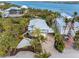 Gorgeous waterfront home with lush landscaping, paver drive and walkway leading to the front door at 79 Palm Dr, Placida, FL 33946