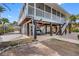 Side view of the home, featuring a covered patio and carport at 79 Palm Dr, Placida, FL 33946