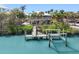 Beautiful waterfront home featuring a private dock, boat lift and lush tropical landscaping at 79 Palm Dr, Placida, FL 33946