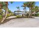 Charming coastal home featuring lush tropical landscaping and a classic light-blue exterior at 79 Palm Dr, Placida, FL 33946
