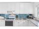 Modern kitchen with white cabinets, granite countertops, and stainless steel appliances at 79 Palm Dr, Placida, FL 33946