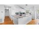 Bright kitchen with white cabinets, stainless appliances, island, and a stylish backsplash at 79 Palm Dr, Placida, FL 33946