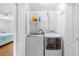 Convenient laundry area includes a modern washer and dryer set with built-in shelving for supplies at 79 Palm Dr, Placida, FL 33946