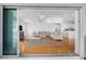 Bright living room with light hardwood floors, comfortable seating, and sliding glass doors to the outdoor space at 79 Palm Dr, Placida, FL 33946