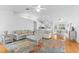 Spacious living room with hardwood floors, plush seating, and plenty of natural light creates a warm and inviting atmosphere at 79 Palm Dr, Placida, FL 33946