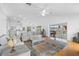 Open-concept living area with hardwood floors and access to a balcony, perfect for seamless indoor-outdoor living at 79 Palm Dr, Placida, FL 33946
