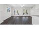 Bright living room with wood-look floors and French doors leading to the outdoors at 79 Palm Dr, Placida, FL 33946