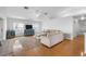 Spacious living room with hardwood floors, neutral decor, and lots of natural light at 79 Palm Dr, Placida, FL 33946
