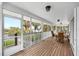 Spacious screened patio with wood flooring and comfortable seating, offering scenic water views at 79 Palm Dr, Placida, FL 33946