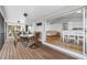 Inviting screened patio with wood floors, dining table, and a glimpse into the home's open living space at 79 Palm Dr, Placida, FL 33946