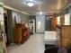 Spacious basement area with tile flooring and various furniture pieces at 8537 Cameo Dr, New Port Richey, FL 34654