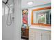Bathroom with a shower and vanity, featuring colorful octopus and seashell art at 8537 Cameo Dr, New Port Richey, FL 34654