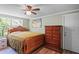 Well-lit bedroom featuring a wooden bed frame and a decorative ceiling fan at 8537 Cameo Dr, New Port Richey, FL 34654