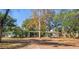 Single story home with mature trees providing shade on a sunny day at 8537 Cameo Dr, New Port Richey, FL 34654