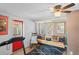 Living room featuring a retro couch, a treadmill, and a vibrant red door at 8537 Cameo Dr, New Port Richey, FL 34654