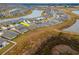 Stunning aerial view of a lakeside community highlighting the home's location, landscaping, and proximity to water features at 11307 Linden Depot Rd, San Antonio, FL 33576