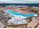 Wide aerial shot of a lagoon and recreational area featuring beach, seating, and water activities at 11307 Linden Depot Rd, San Antonio, FL 33576