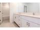 Bathroom featuring double vanity, quartz countertop, and subway tile shower at 11307 Linden Depot Rd, San Antonio, FL 33576