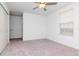 A neutral bedroom with gray carpet, a ceiling fan and closet at 11307 Linden Depot Rd, San Antonio, FL 33576
