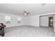 Spacious bonus room featuring natural light, carpet, and a games table with views of the adjacent bathroom at 11307 Linden Depot Rd, San Antonio, FL 33576