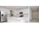 Contemporary kitchen featuring stainless steel appliances, a large island, and ample white cabinetry at 11307 Linden Depot Rd, San Antonio, FL 33576