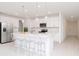 Modern kitchen with white cabinetry, stainless steel appliances, a large island, and pendant lighting at 11307 Linden Depot Rd, San Antonio, FL 33576
