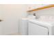 Efficient laundry room featuring a side-by-side washer and dryer with upper shelving at 11307 Linden Depot Rd, San Antonio, FL 33576