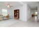 Bright living room with stylish décor, including a desk, bookshelf, and neutral rug on tile flooring at 11307 Linden Depot Rd, San Antonio, FL 33576