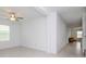 Bright living room with white walls, tile flooring, ceiling fan, and ample natural light at 11307 Linden Depot Rd, San Antonio, FL 33576