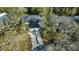 Aerial view of a well maintained home with mature trees and inviting driveway, offering great curb appeal at 12411 Cavalier Ct, Hudson, FL 34669