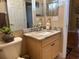 Neutral bathroom featuring a vanity with granite countertop, a toilet, and a large mirror at 12411 Cavalier Ct, Hudson, FL 34669