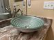 Close-up of a stylish glass vessel sink with modern faucet and granite countertop at 12411 Cavalier Ct, Hudson, FL 34669