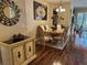Dining room with hardwood floors, a decorative rug, and an ornate dining table with seating for six at 12411 Cavalier Ct, Hudson, FL 34669