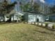 Charming single-story home featuring a well-manicured lawn and a two-car garage in a peaceful neighborhood at 12411 Cavalier Ct, Hudson, FL 34669