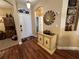 Foyer with hardwood floors, decorative cabinet, and arched doorway to adjacent rooms, creating an inviting entrance at 12411 Cavalier Ct, Hudson, FL 34669