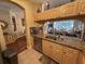 Open concept kitchen with granite countertops, wood cabinets, stainless steel appliances, and tile flooring at 12411 Cavalier Ct, Hudson, FL 34669