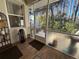 Enclosed back patio featuring tile floors, natural light and a backyard view at 12411 Cavalier Ct, Hudson, FL 34669