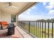 Relaxing covered balcony with comfortable seating and a beautiful view of the lake at 12854 Boggy Creek Dr, Riverview, FL 33579
