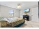 This bedroom features a window, closet and fireplace with a TV above it at 12854 Boggy Creek Dr, Riverview, FL 33579