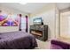Cozy bedroom featuring fireplace under TV, artwork, and elegant decor at 12854 Boggy Creek Dr, Riverview, FL 33579