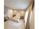 Bright bedroom featuring a bed with gold accents, decorative curtains, and complementary furniture at 12854 Boggy Creek Dr, Riverview, FL 33579