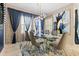 Elegant dining room with stylish decor, a glass-top table, and a modern chandelier at 12854 Boggy Creek Dr, Riverview, FL 33579