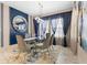 Stylish dining room with a glass-top table, modern decor, and a contemporary light fixture at 12854 Boggy Creek Dr, Riverview, FL 33579
