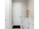 Hallway with white cabinets, marble countertops, and a door at 12854 Boggy Creek Dr, Riverview, FL 33579