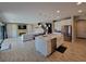 Open-concept kitchen with a kitchen island, stainless steel appliances, and white cabinetry at 12854 Boggy Creek Dr, Riverview, FL 33579