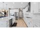 Spacious, modern kitchen with white cabinets, stainless steel appliances, and a large kitchen island at 12854 Boggy Creek Dr, Riverview, FL 33579